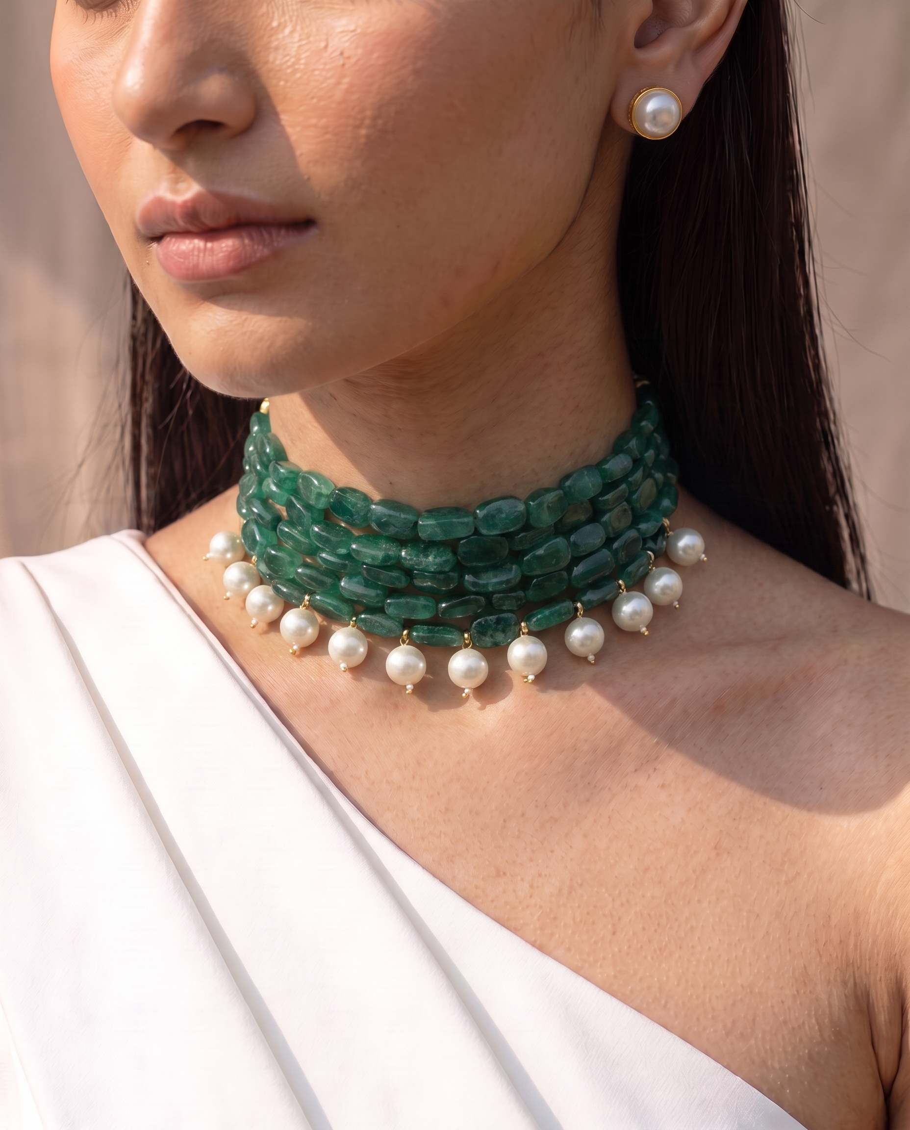 Four strands of green stone with white pearl drops, plus matching studs. A choker that finishes a plain neckline. Anti-tarnish, gold-toned finish.