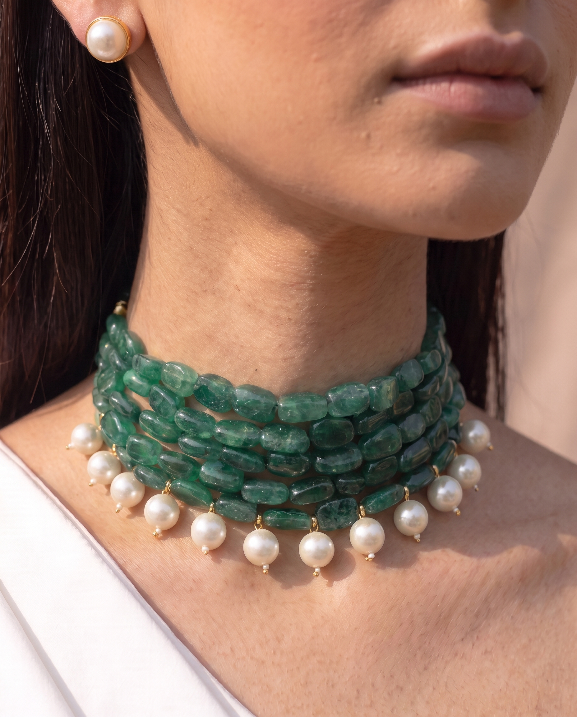 Four strands of green stone with white pearl drops, plus matching studs. A choker that finishes a plain neckline. Anti-tarnish, gold-toned finish.