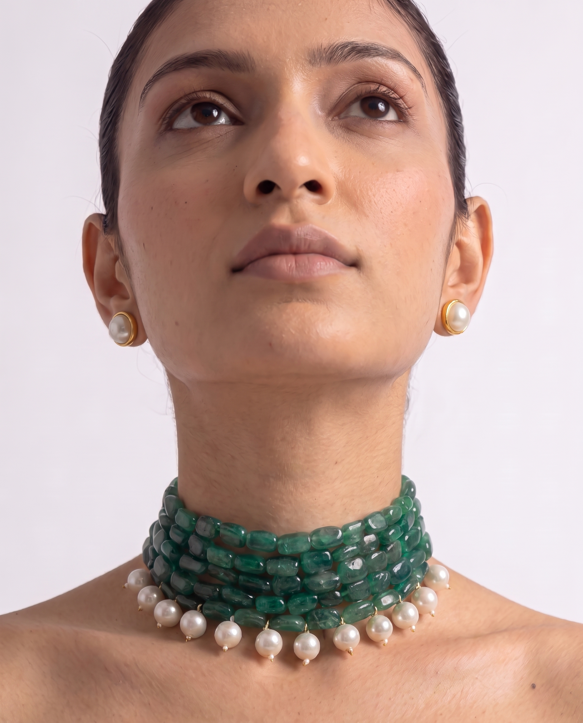 Five strands of green stone with white pearl drops, plus matching studs. A choker that finishes a plain neckline. Anti-tarnish, gold-toned finish.