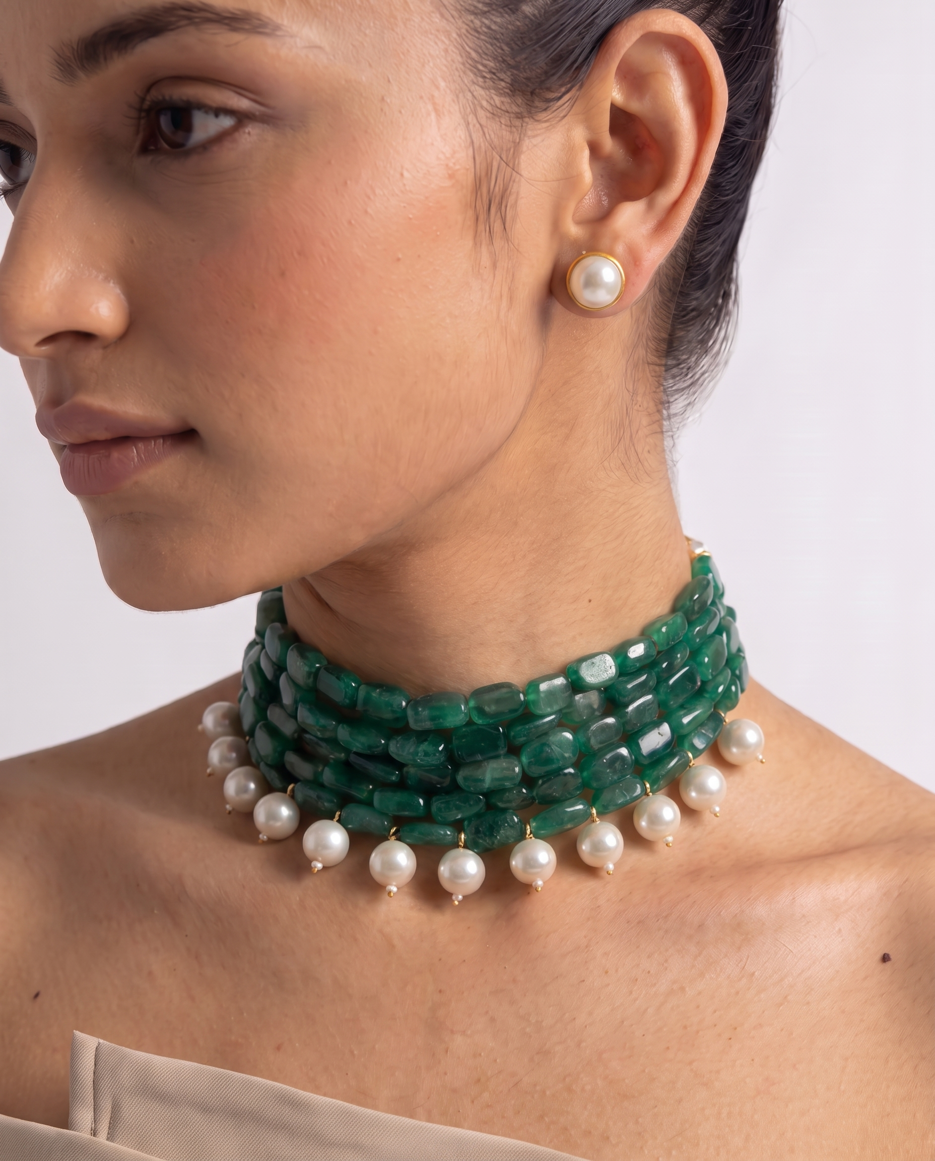Five strands of green stone with white pearl drops, plus matching studs. A choker that finishes a plain neckline. Anti-tarnish, gold-toned finish.